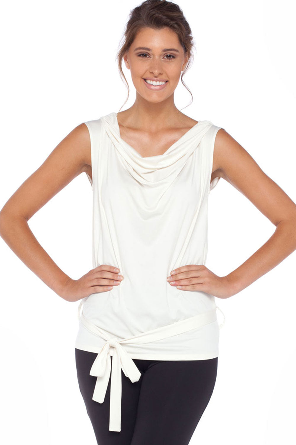 A woman wears a sleeveless hoodie top in ivory slinky jersey. With oversized hoodie, and belt ties at the hips, this slinky jersey hooded top is comfortable for petite to plus size, curvy women. Styled as a summer top, this lightweight casual top makes a good travel top for holiday capsule wardrobes. Shop online at Australian leisurewear brand, Urban Silk's online clothes boutique!
