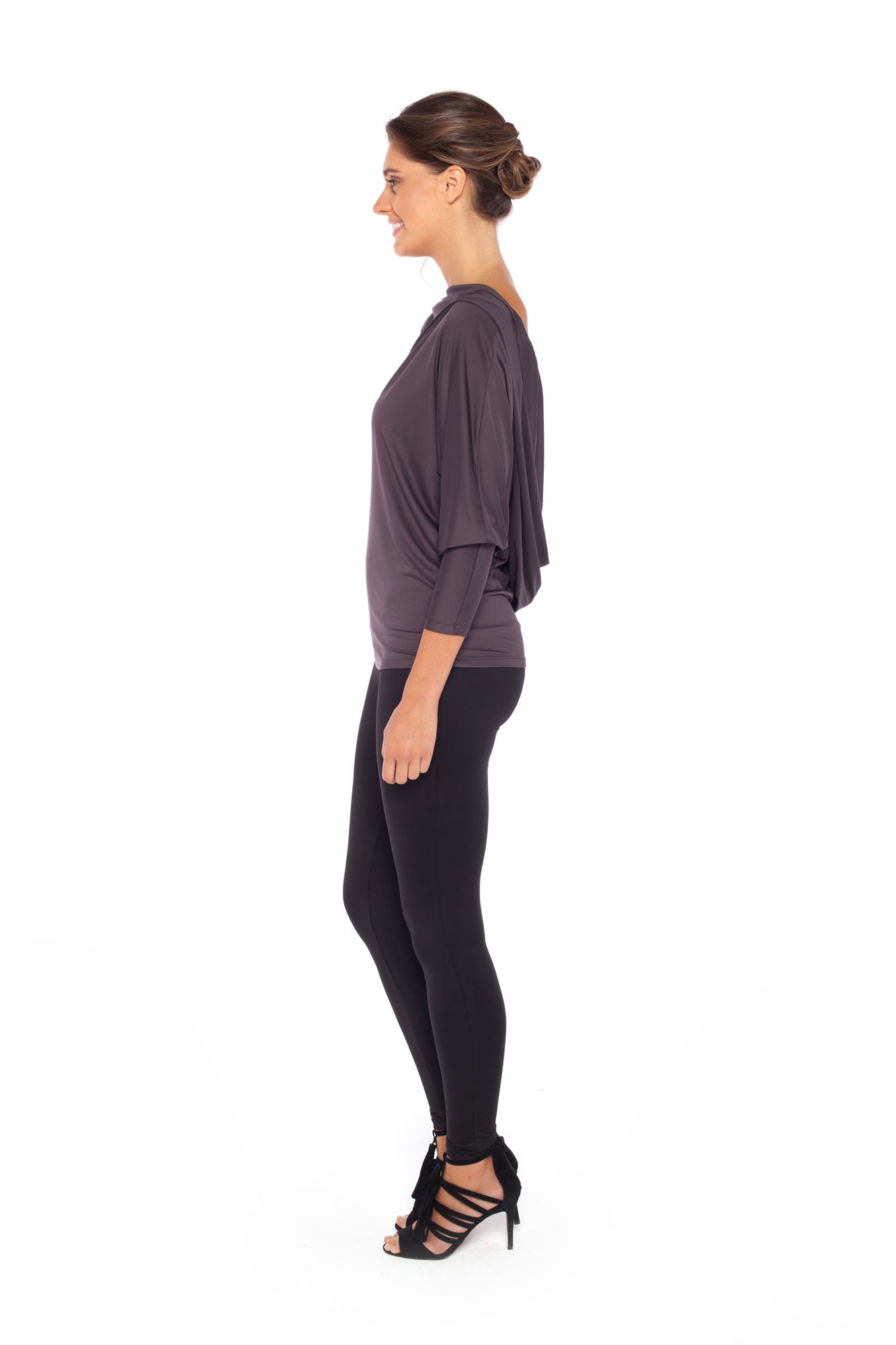 Woman wearing a hooded top in slinky jersey with batwing sleeves worn with slim-leg, long-length, black legging trousers and styled with heels for work wear style or low-key going out style. Designed in Australia and made for petite to plus size women