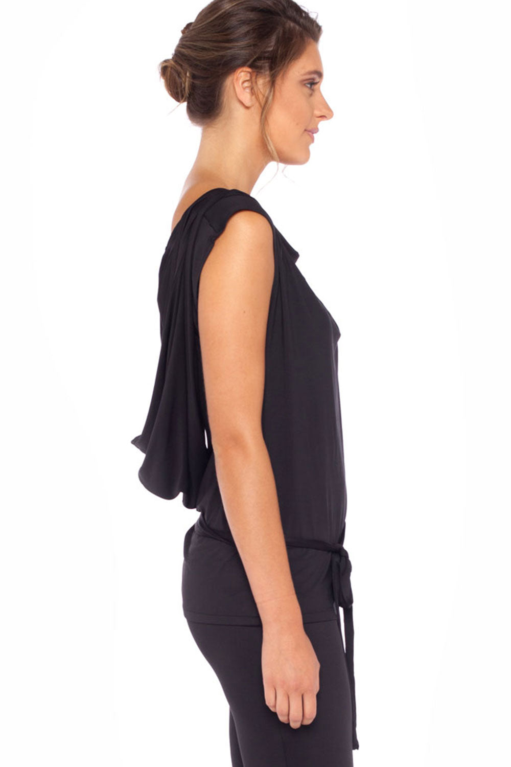 Side view of a woman wearing a black, sleeveless hoodie top by Australian leisurewear brand, Urban Silk. Showing an oversized hood, this elegant top drapes in slinky jersey to give an elevated leisurewear look. Click to shop in Urban Silk's clothing boutique.