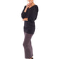 A woman wears a long sleeve hoodie top in black slinky jersey. The hoodie sweatshirt is worn with a slinky jersey tube skirt in khaki grey worn as a maxi skirt and styled for evening as a going out dress. Both hoodie top and tube skirt are by Australian women's fashion brand, Urban Silk who specialise in leisurewear clothing women can wear for work, travel and casual wear.