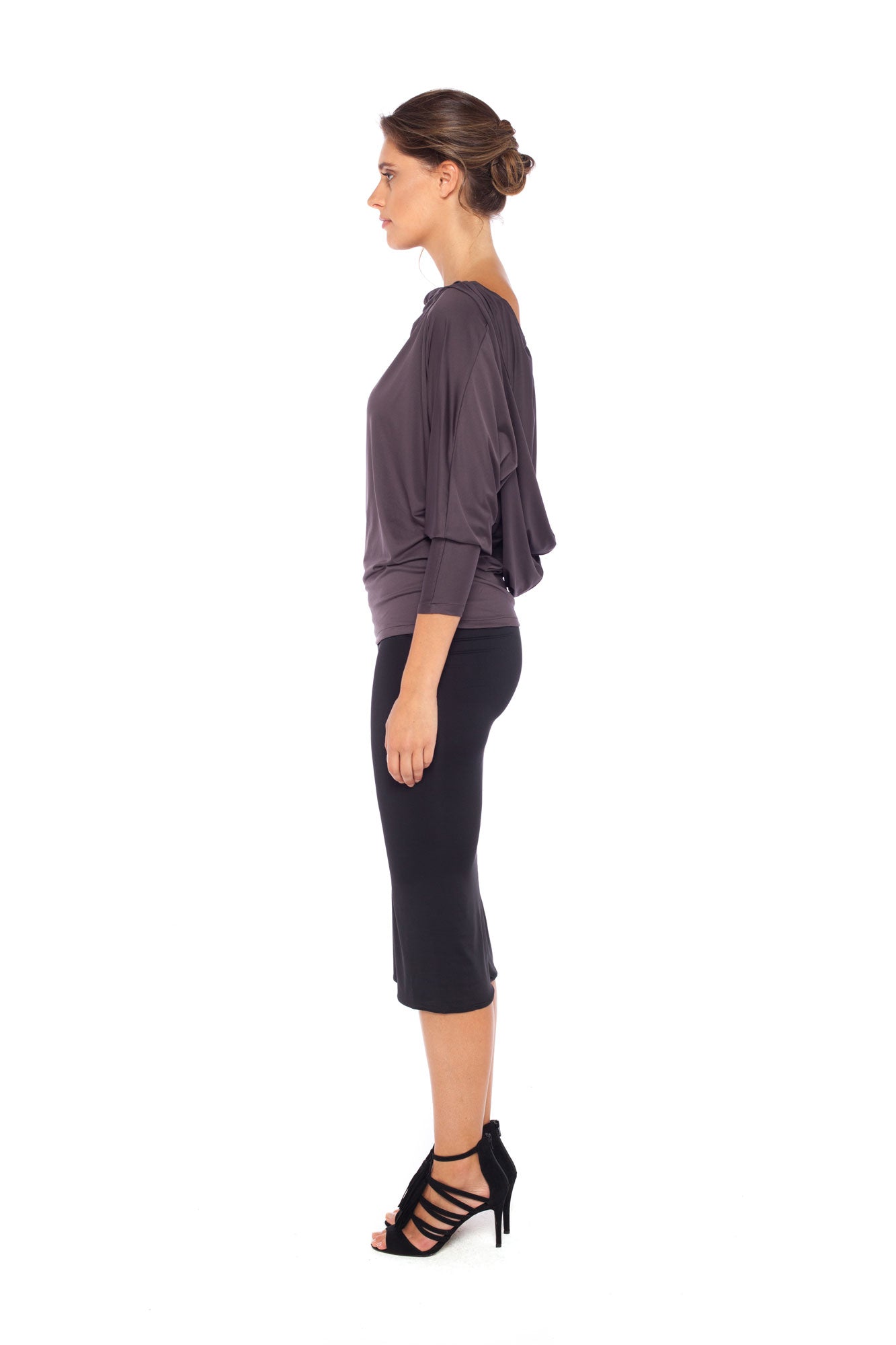 Woman wearing a hooded top in slinky jersey with jersey cylinder-cut black pencil skirt and styled with heels for work wear clothing or low-key going out style. Designed in Australia and made for petite to plus size women