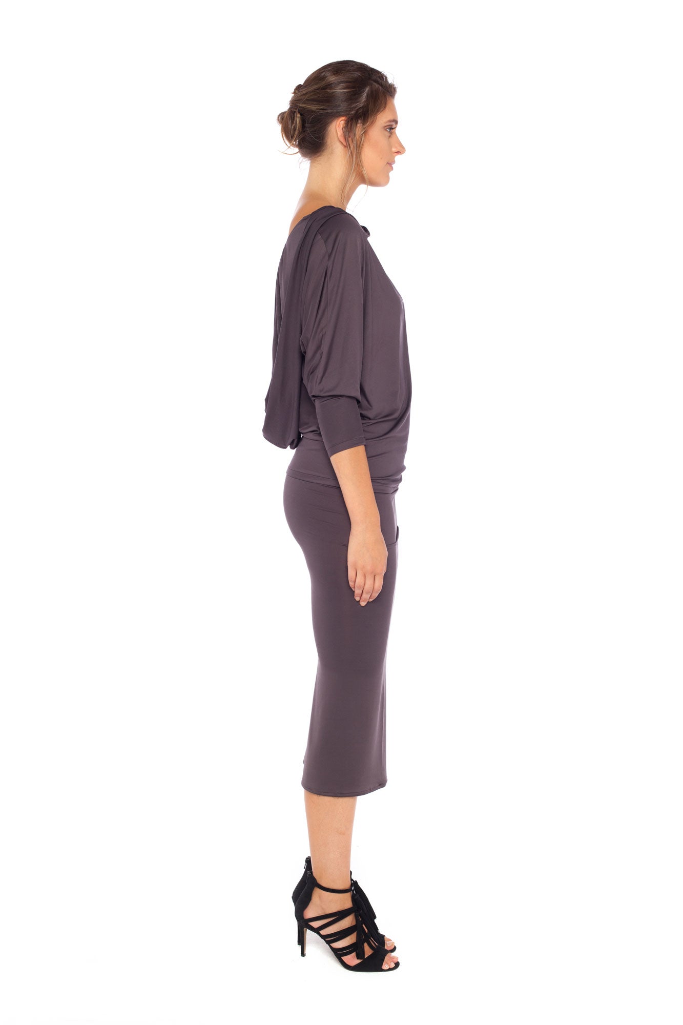 Woman wearing a hooded top in slinky jersey with batwing sleeves worn with a cylinder-shape pencil skirt and styled with heels for work wear style or low-key going out style. Designed in Australia and made for petite to plus size women