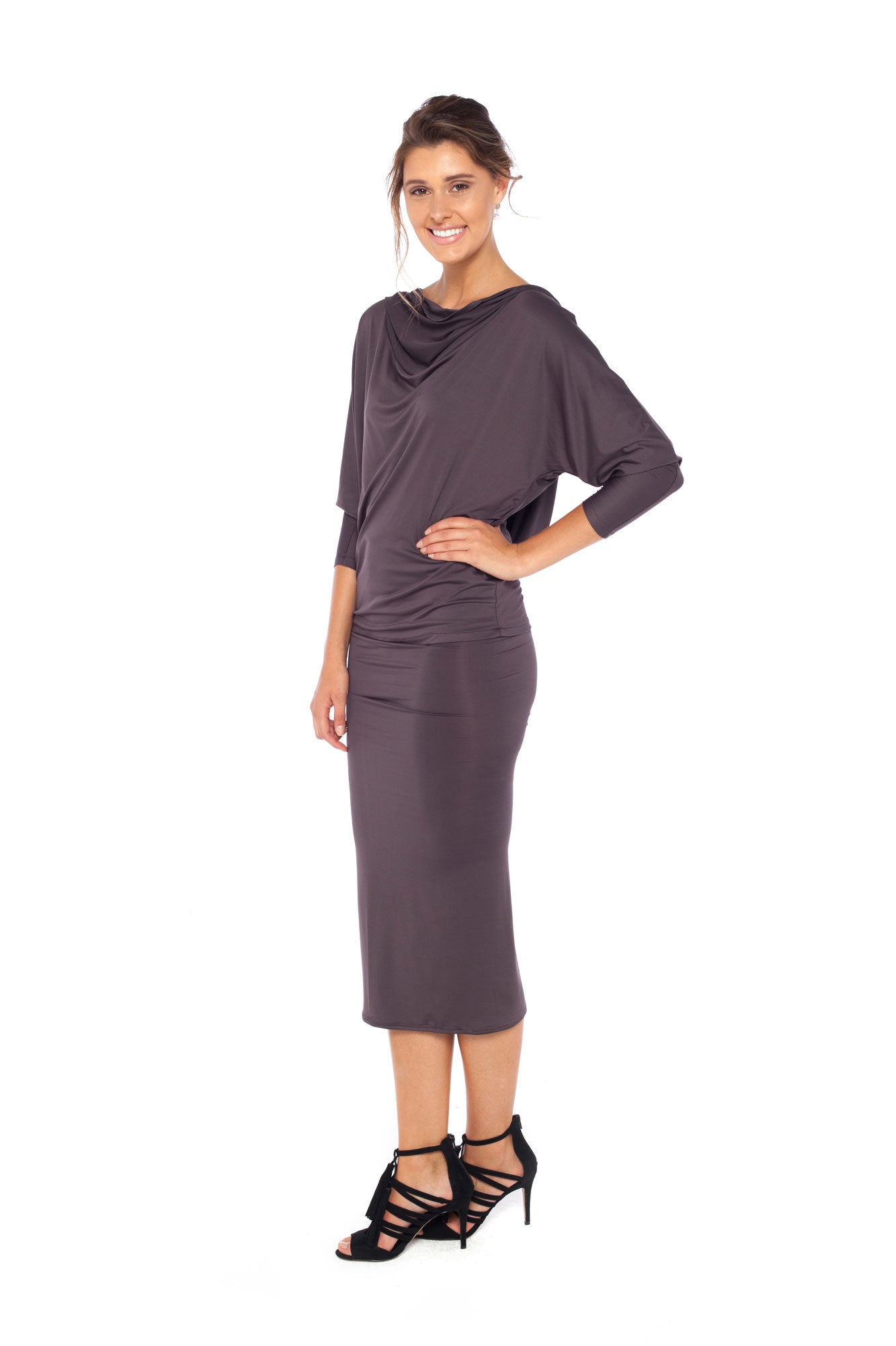 Woman wearing a hooded top in slinky jersey with batwing sleeves worn with a cylinder-shape pencil skirt and styled with heels for work wear style or low-key going out style. Designed in Australia and made for petite to plus size women