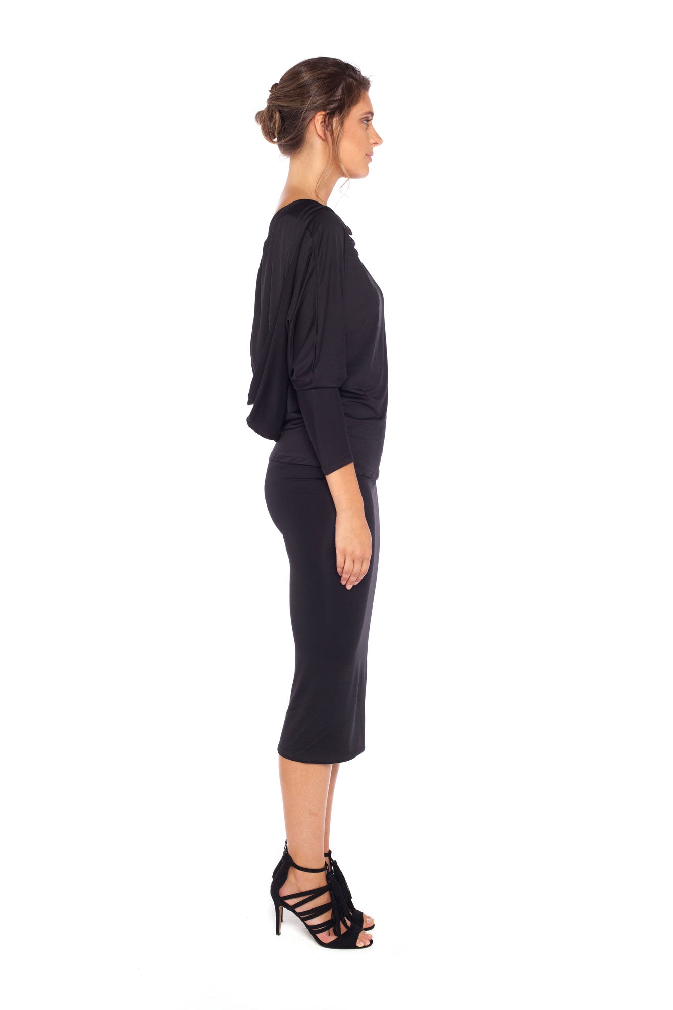 Woman wearing black jersey hooded top with batwing sleeves worn with black cylinder-shape pencil skirt and styled with heels for work style or low-key evening glamour. shop jersey tops and skirts designed in Australia for petite to plus size women.