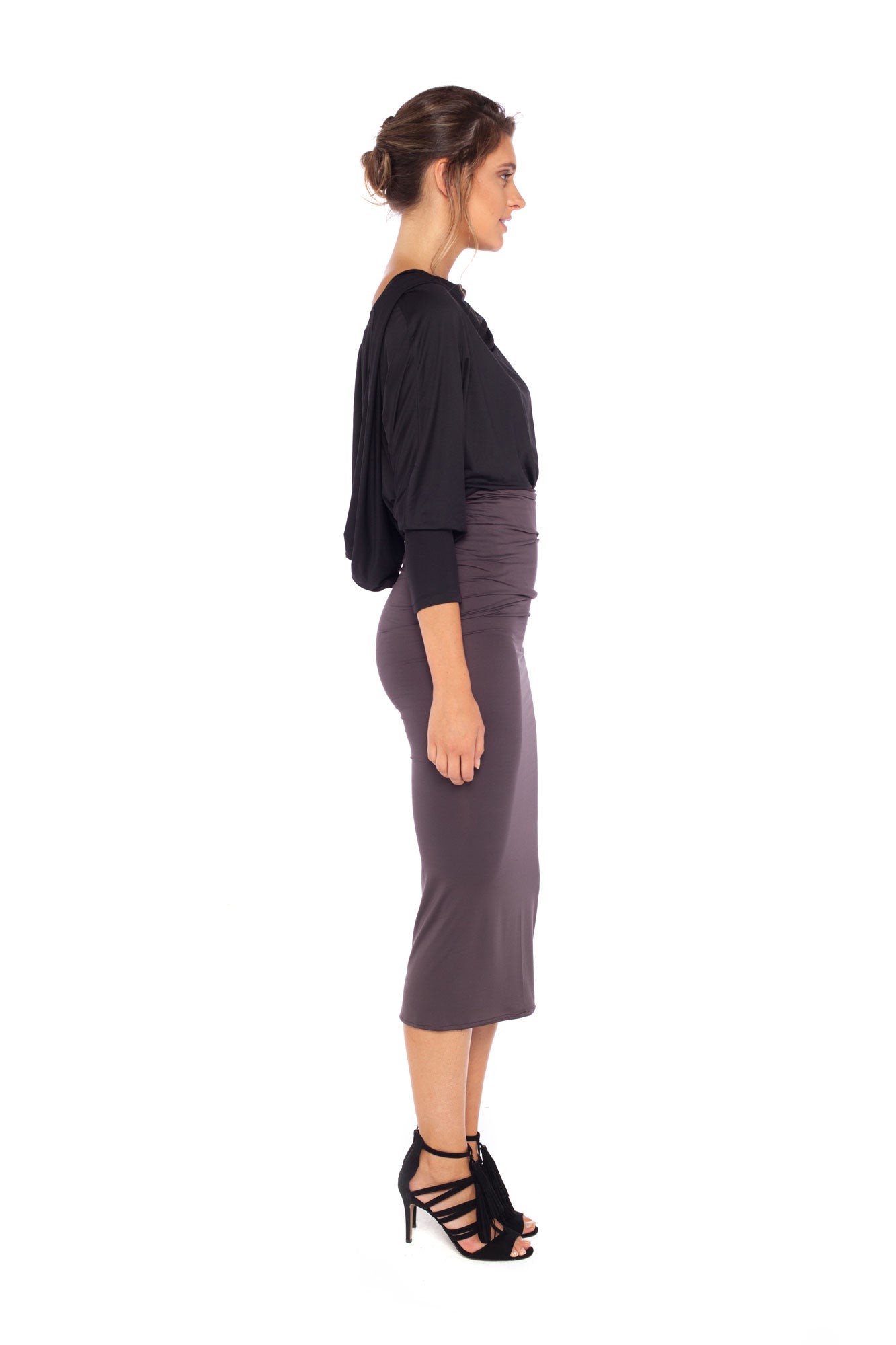 Woman wearing black jersey hooded top with batwing sleeves worn tucked into cylinder-shaped pencil skirt in Donkey and heels for a work wear look or going out style. Designed in Australia for petite to plus size women.