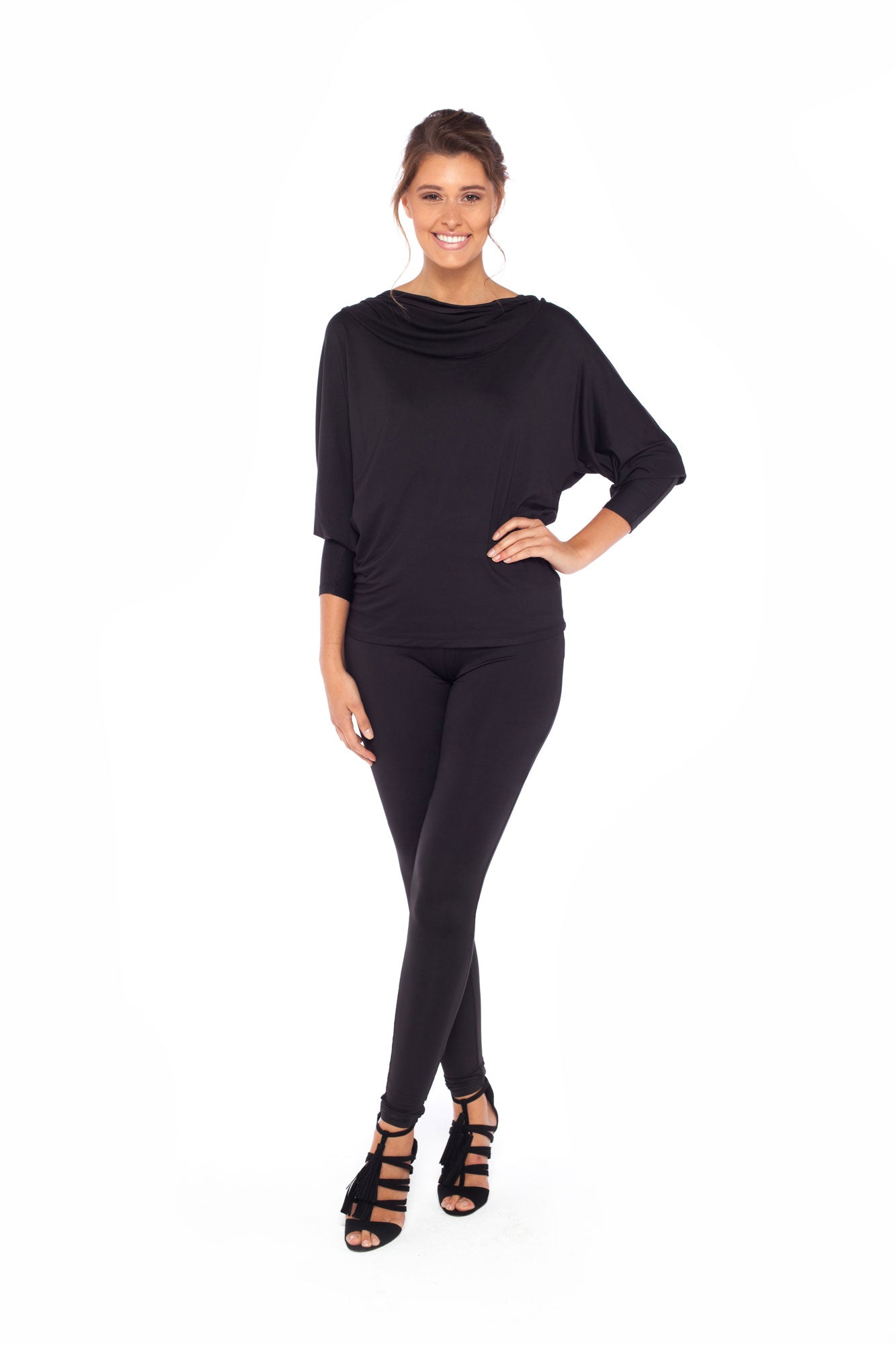 Woman wearing black jersey hooded top with batwing sleeves worn with black slim leg legging pants and styled with heels for work style or low-key evening glamour. shop jersey tops and pants designed in Australia for petite to plus size women.