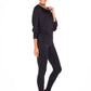 Woman wearing black jersey hooded top with batwing sleeves worn with black slim leg legging pants and styled with heels for work style or low-key evening glamour. shop jersey tops and pants designed in Australia for petite to plus size women.