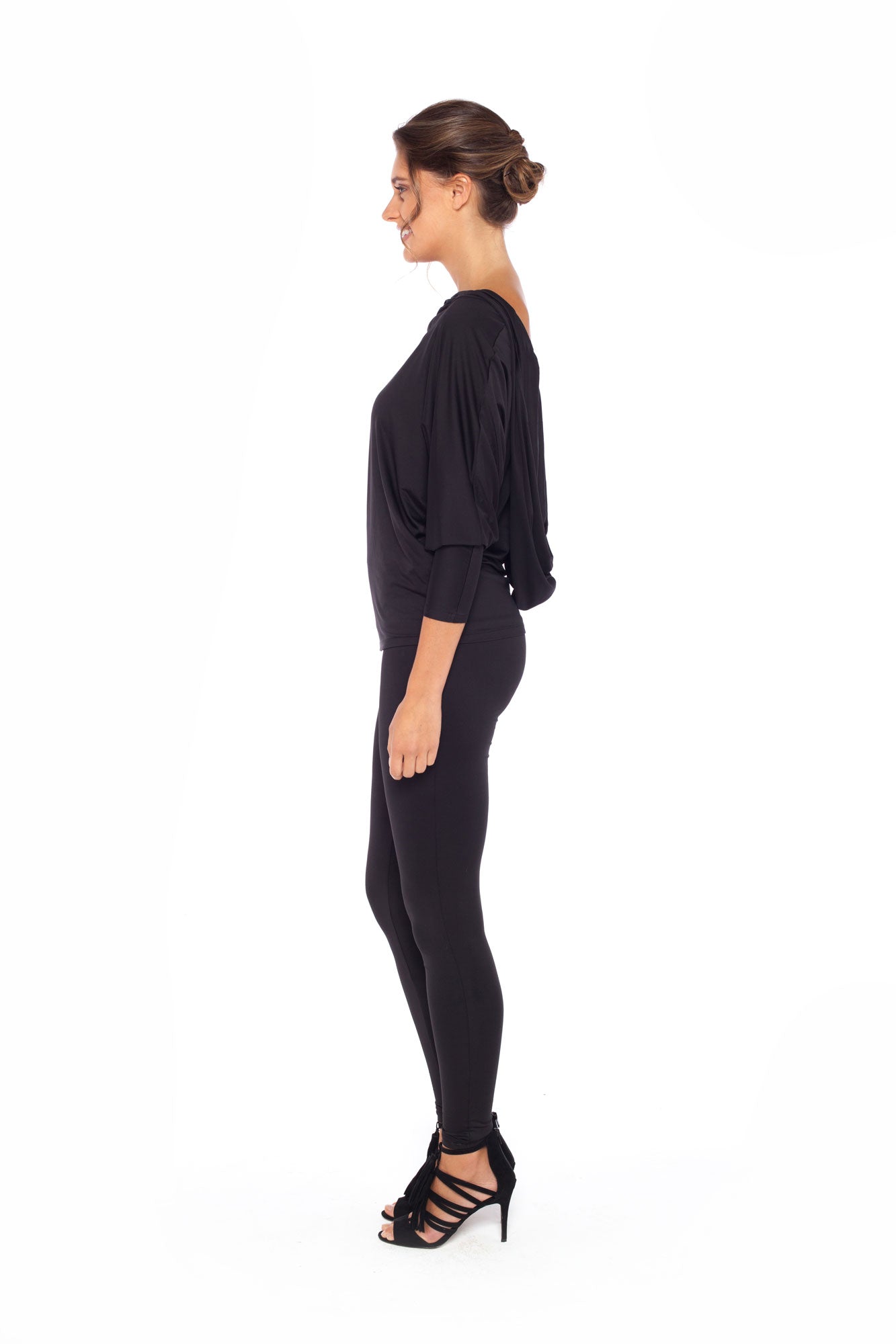 Woman wearing black jersey hooded top with batwing sleeves worn with black slim leg legging pants and styled with heels for work style or low-key evening glamour. shop jersey tops and pants designed in Australia for petite to plus size women.