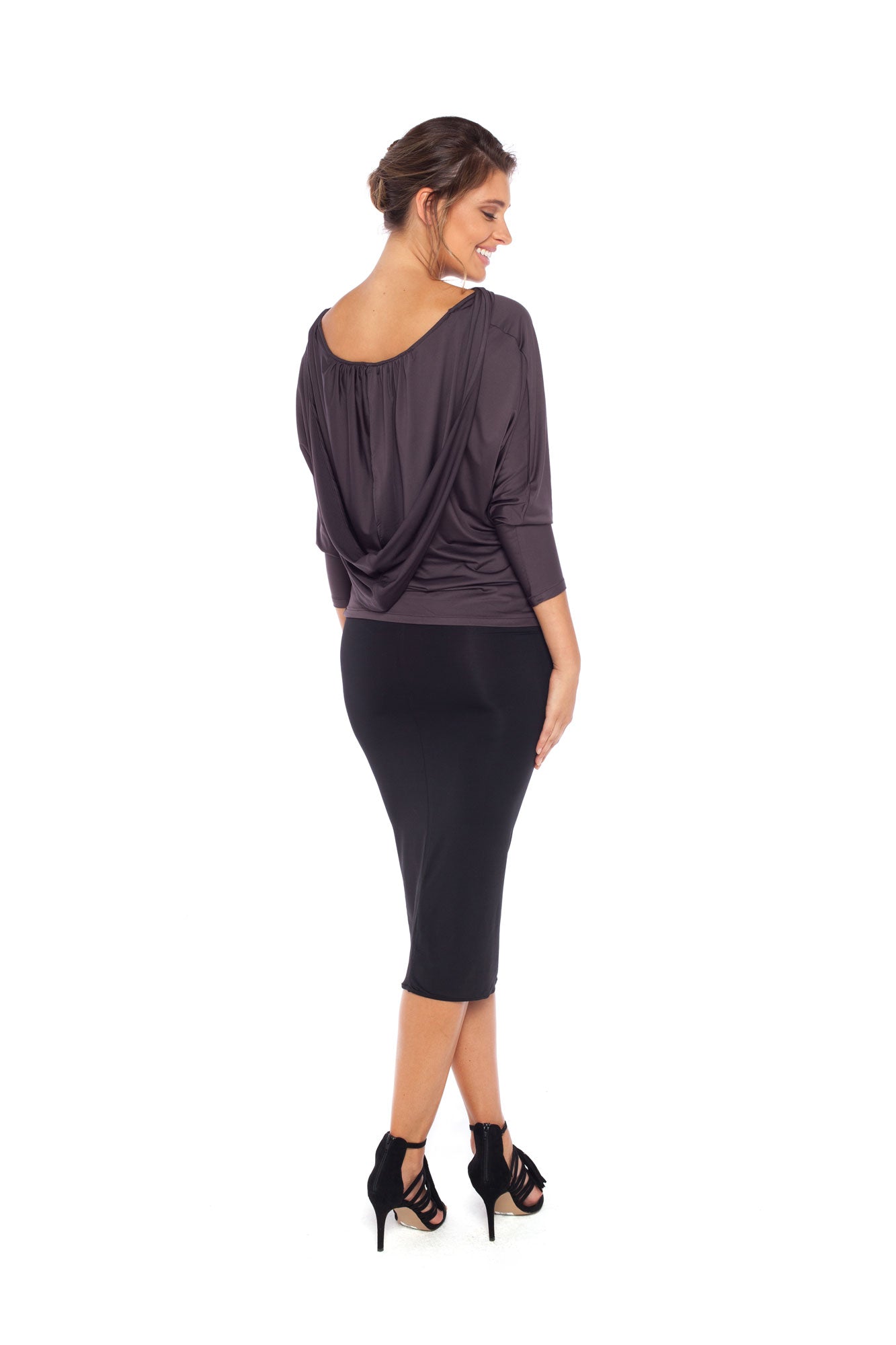 Woman wearing a hooded top in slinky jersey with jersey cylinder-cut black pencil skirt and styled with heels for work wear clothing or low-key going out style. Designed in Australia and made for petite to plus size women