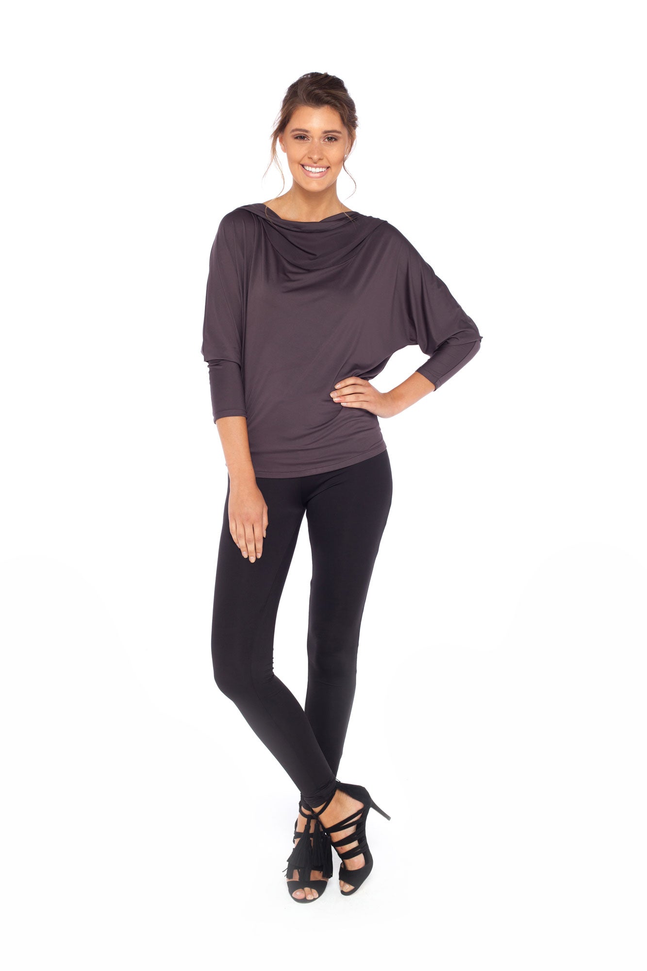 Woman wearing a hooded top in slinky jersey with batwing sleeves worn with slim-leg, long-length, black legging trousers and styled with heels for work wear style or low-key going out style. Designed in Australia and made for petite to plus size women