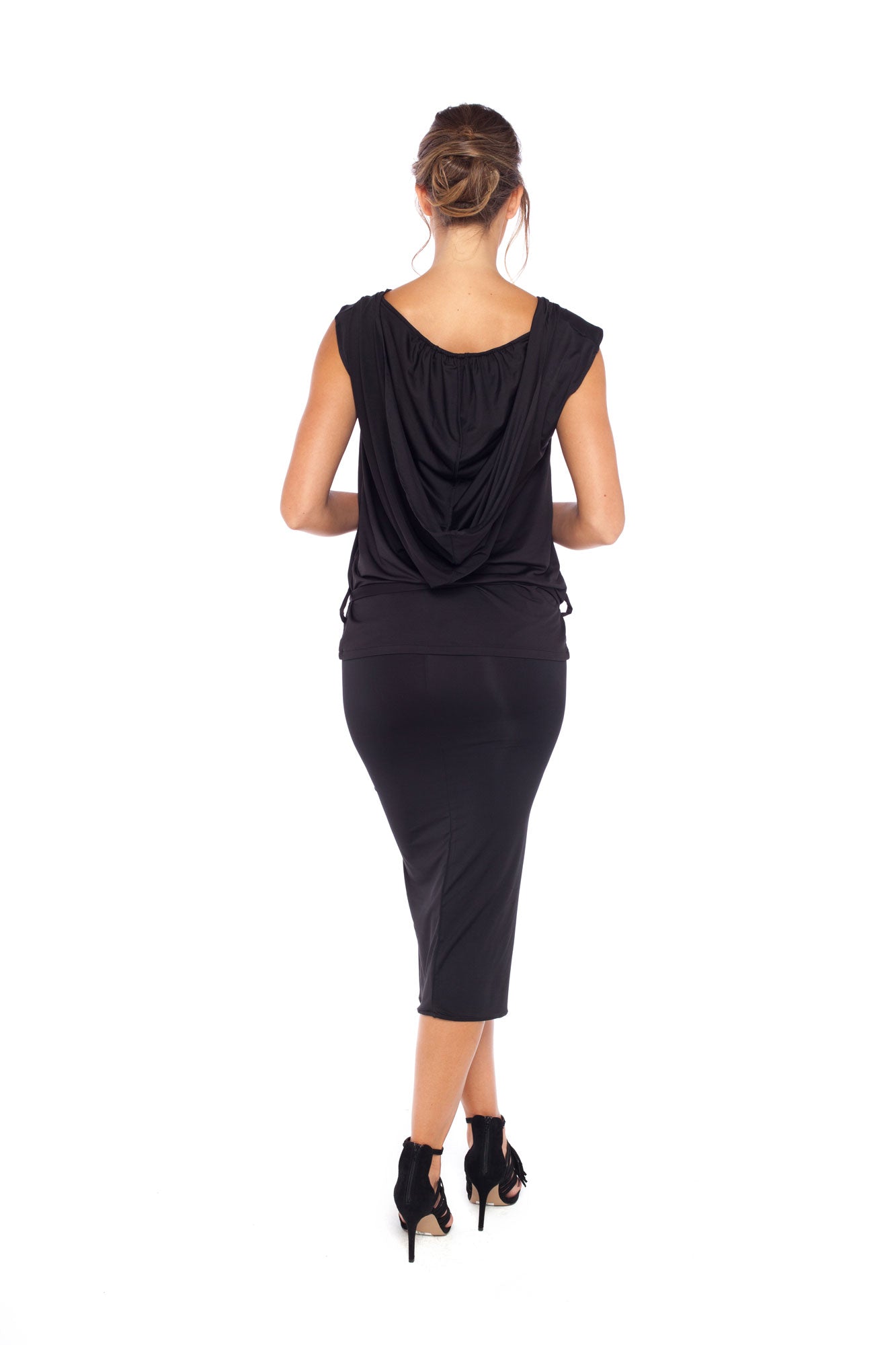 Back view of a woman wearing a black tube skirt worn with a sleeveless black hooded top in silky jersey to give the look of a slinky black hooded jersey dress for relaxed evening glamour and going-out wear style. Designed in Australia by Urban Silk leisurewear.