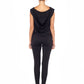 Woman wearing black hooded top in slinky jersey worn with skinny black legging pants and styled with heels to show leisurewear fashion that can be worn for work, casual wear and low-key evening looks. For leisurewear designed in Australia for petite to curvy women, shop online at Urban Silk