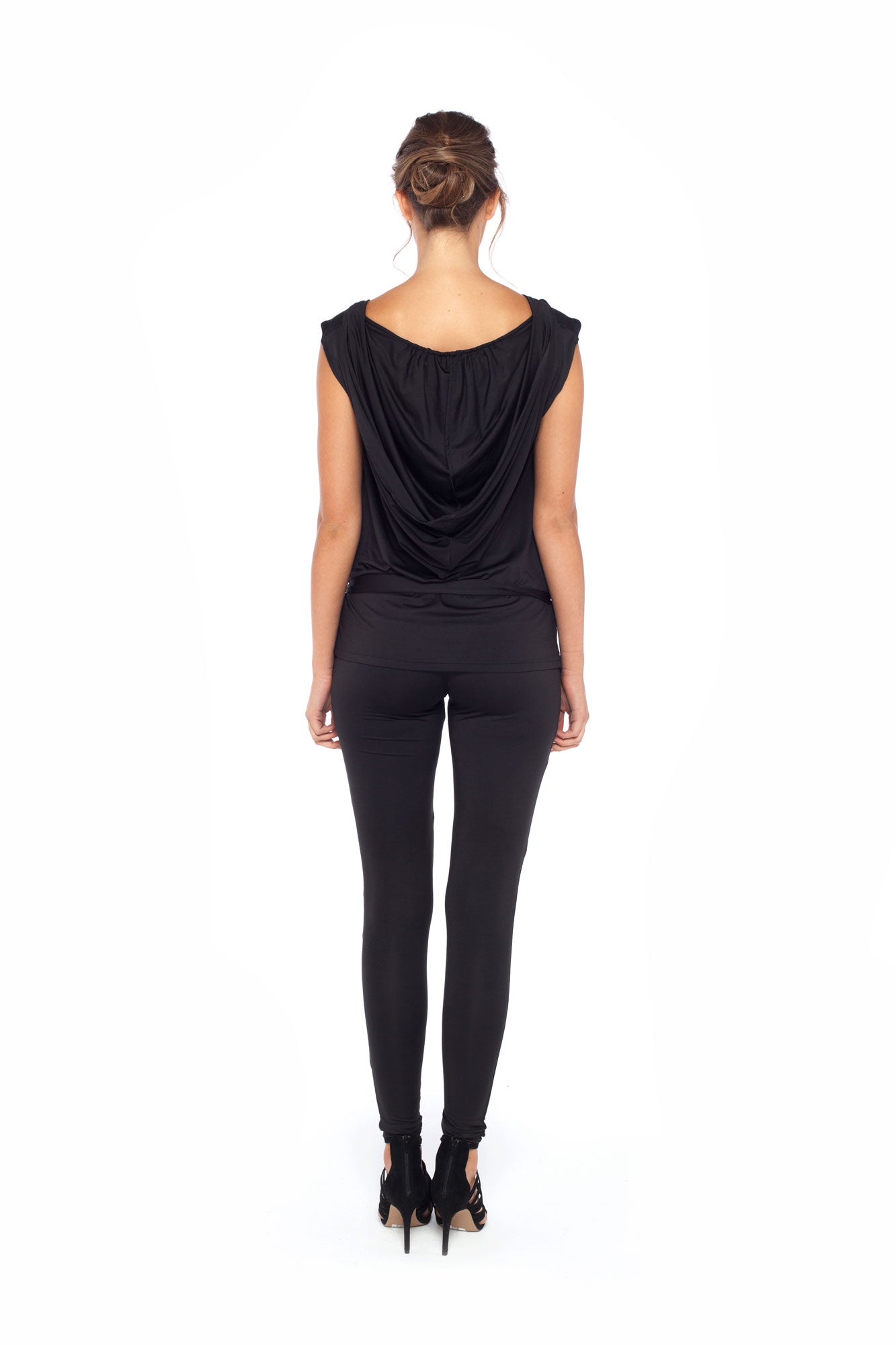 Woman wearing black hooded top in slinky jersey worn with skinny black legging pants and styled with heels to show leisurewear fashion that can be worn for work, casual wear and low-key evening looks. For leisurewear designed in Australia for petite to curvy women, shop online at Urban Silk