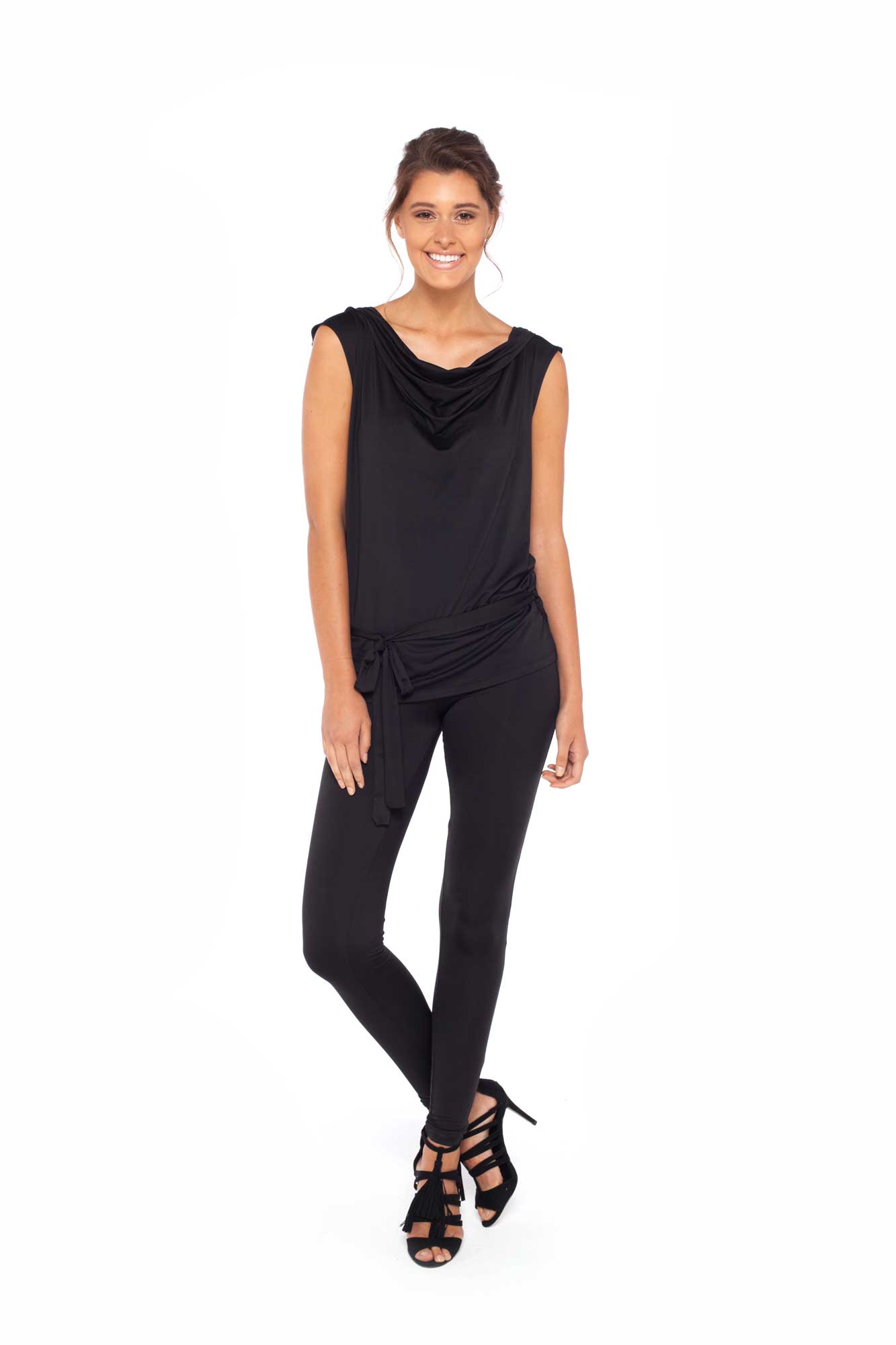 Woman wearing black hooded top in slinky jersey worn with skinny black legging pants and styled with heels to show leisurewear fashion that can be worn for work, casual wear and low-key evening looks. Shop leisurewear designed in Australia for petite to curvy women at Urban Silk