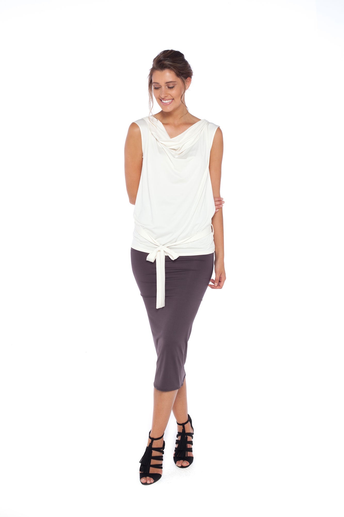 A woman wears Australian leisurewear brand Urban Silk's Sleeveless Hooded jersey Top in Ivory and a khaki jersey tube skirt. Shop smart casual work wear, corporate wear for the young professionals and easy business travel outfits at Urban Silk clothing and feel as good as she looks!