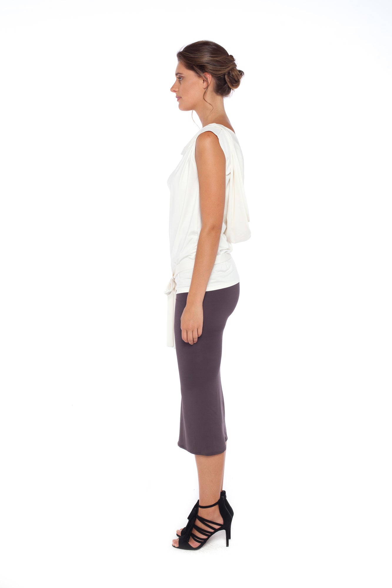 Side view of a woman wearing Australian leisurewear brand Urban Silk's Sleeveless Hooded jersey Top in Ivory and a khaki jersey pencil skirt. Shop smart casual work wear, corporate wear for the young professionals and easy business travel outfits at Urban Silk clothing and feel as good as she looks!