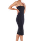 Side view of a woman wearing a strapless black tube dress in silky jersey, styled with black high heels for a going-out, evening look. designed in Australia by Urban Silk leisurewear